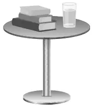 Books and a glass of water on a small round table