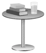 Books and a glass of water on a small round table