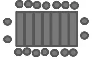 Seven tables joined at their longer sides, with 7 chairs along the top, 7 along the bottom and 2 at each end
